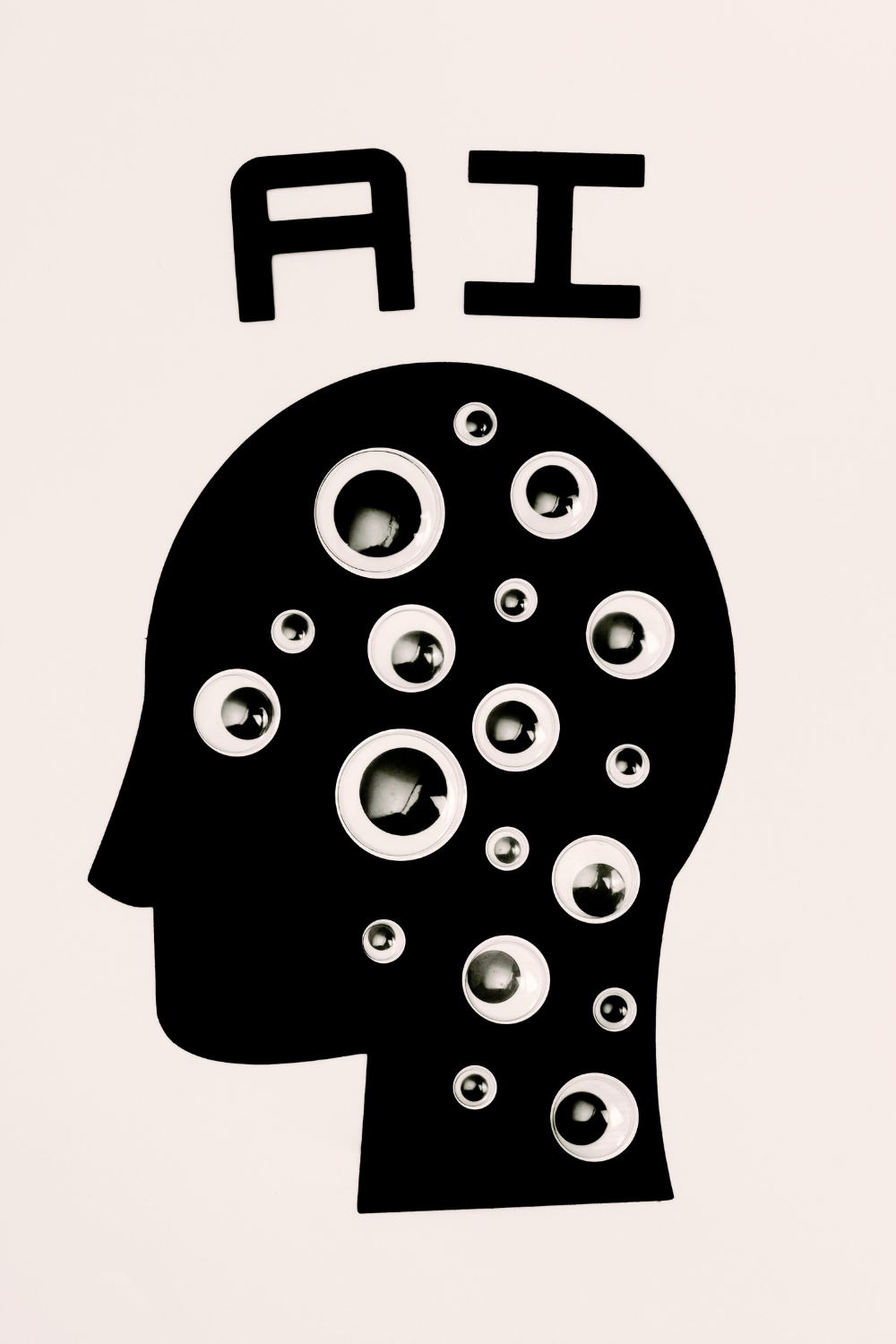 A minimalist image of a black silhouette of a human head on a white background, with abstract circuit patterns symbolizing artificial intelligence and technology.