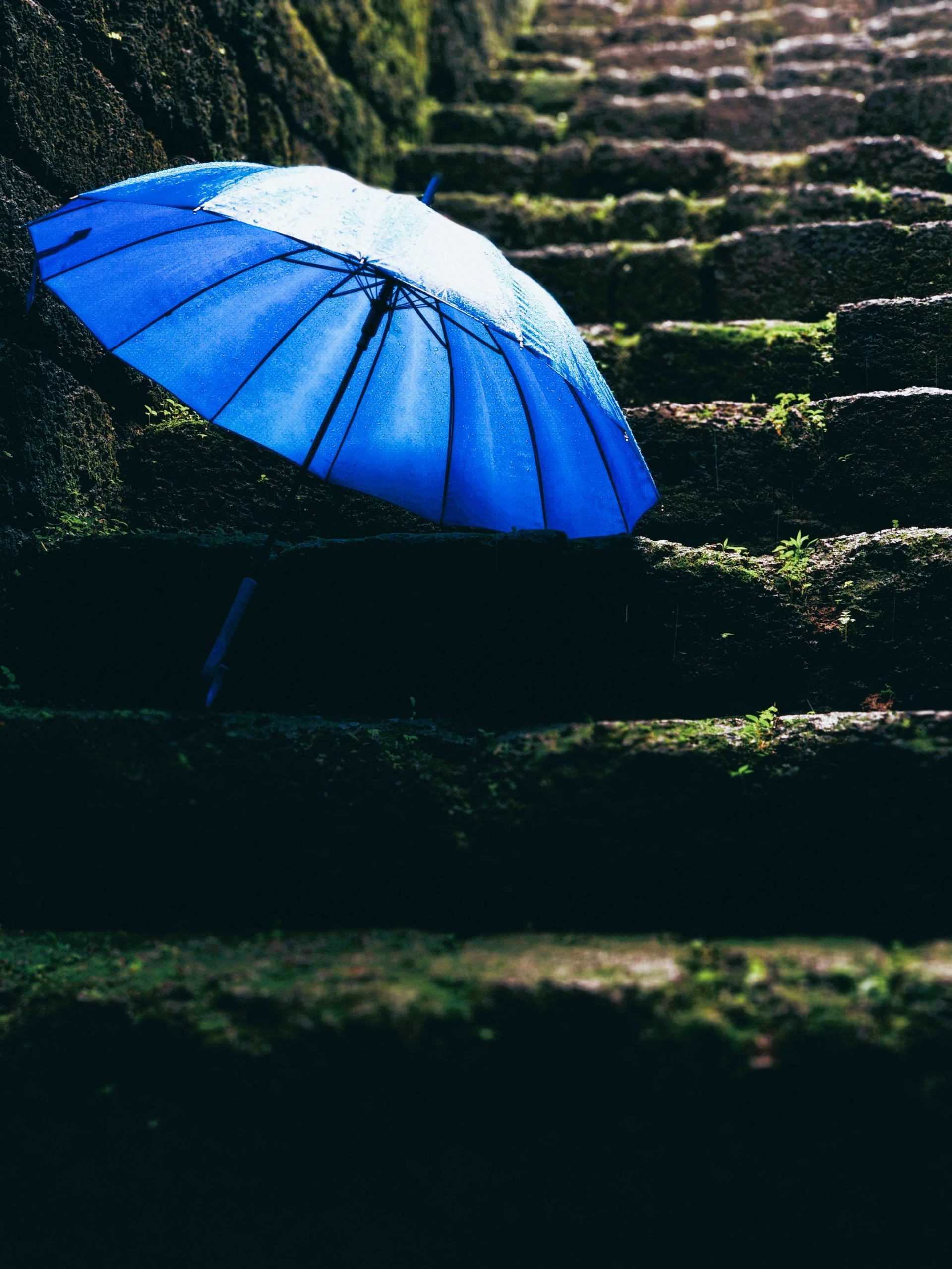 Blue umbrella on the stairs