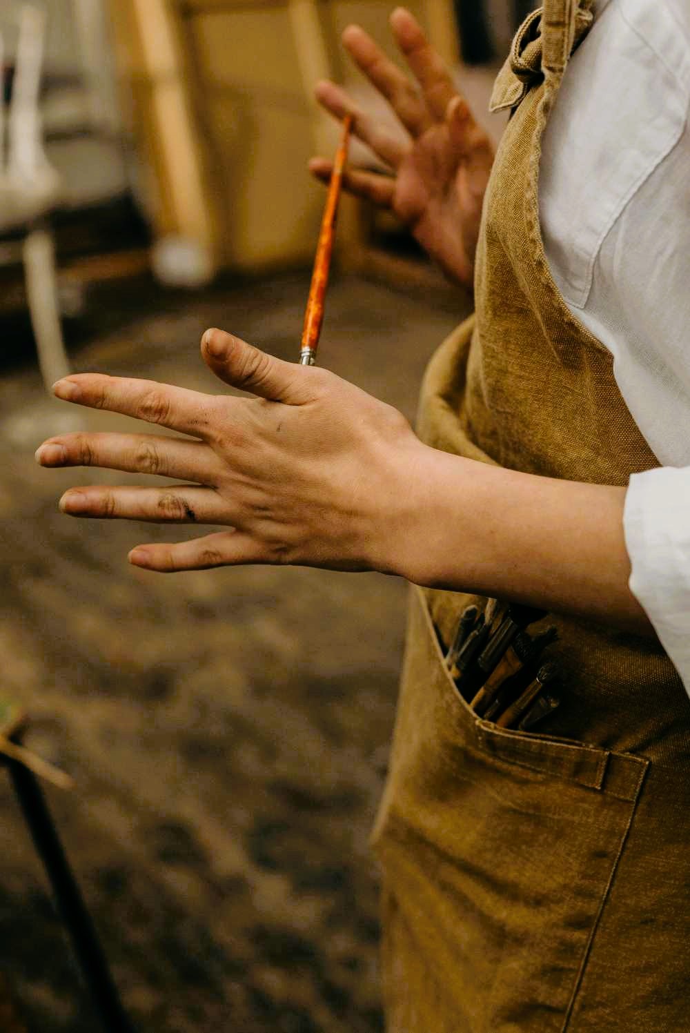 A painter master holding a brush, poised to create.