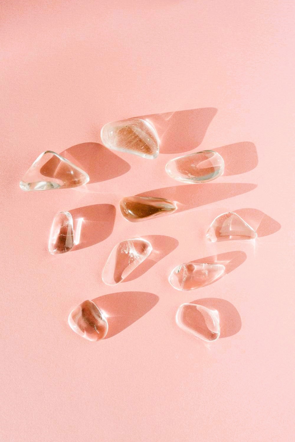 A cluster of clear quartz crystals with radiant, transparent facets that catch the light.