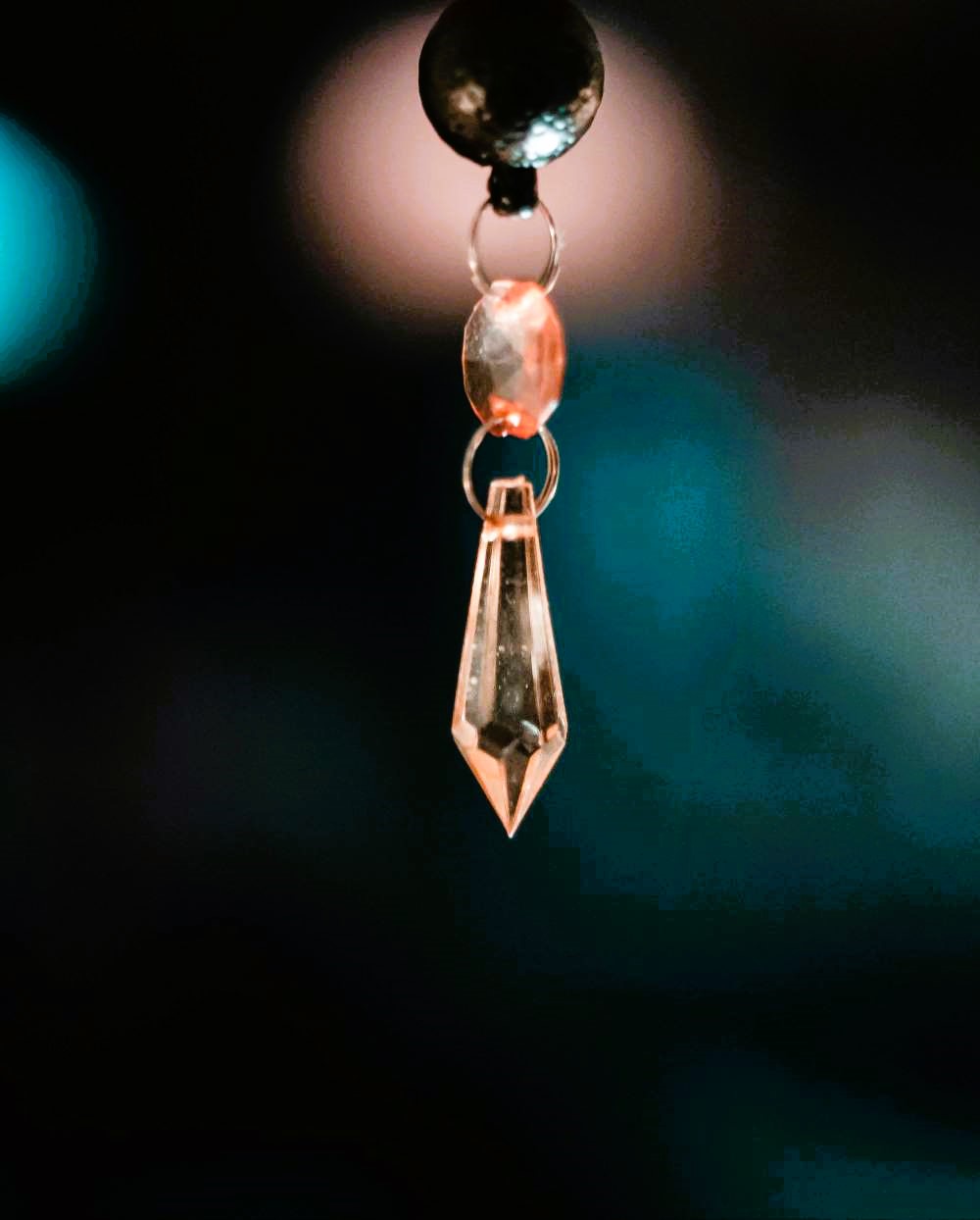 A delicate soft pink rose crystal pendulum.