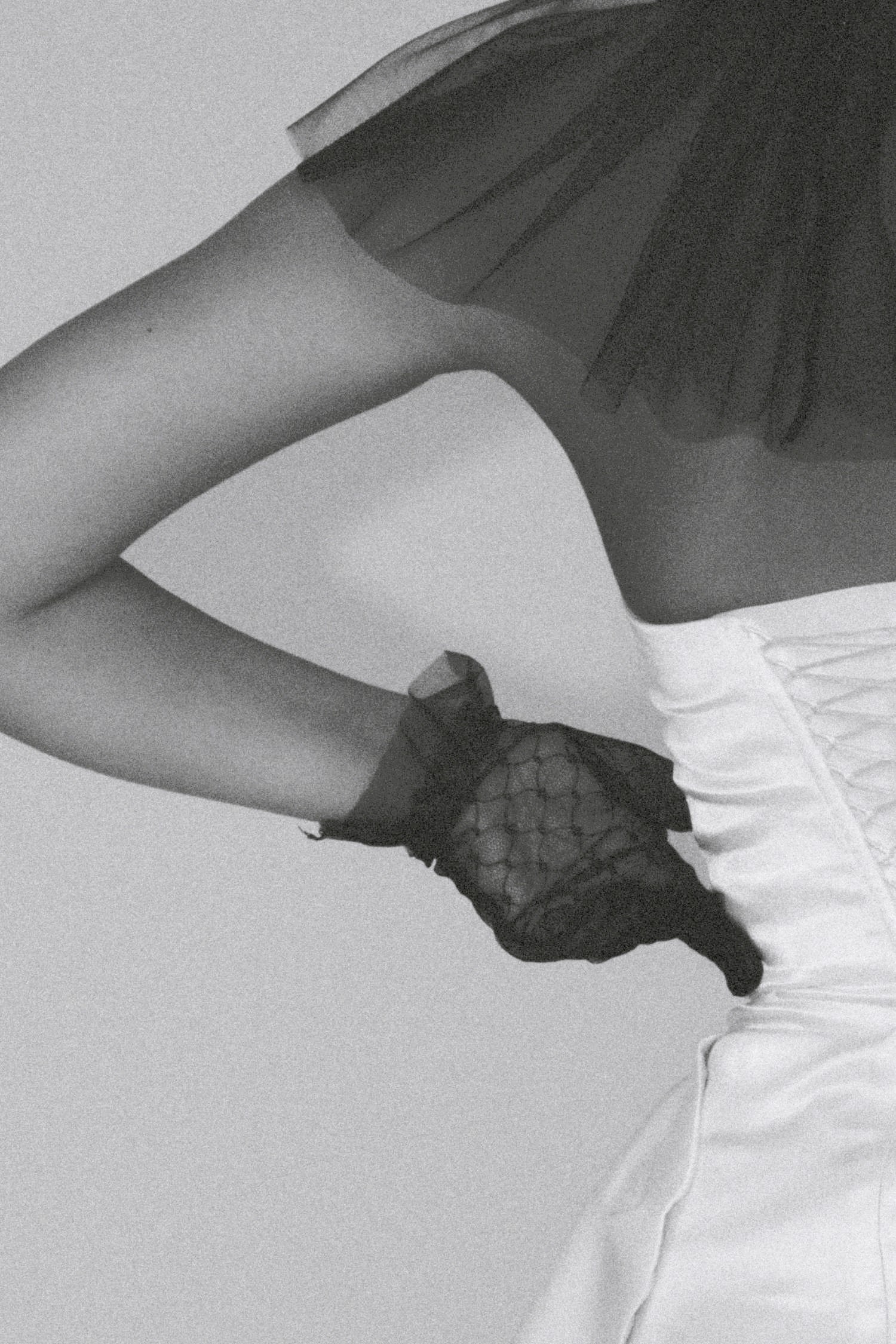 A stylish black-and-white image featuring a fashionable woman in a sleek white dress