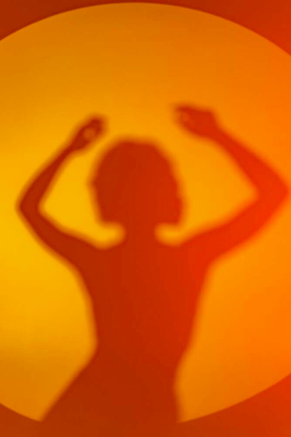 female silhouette in a vibrant orange hue