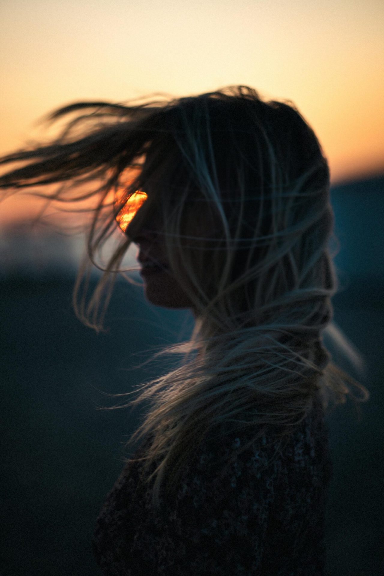 Lady standing in the soft glow of the sunrise, symbolizing new beginnings, growth, and the illumination of personal journey.