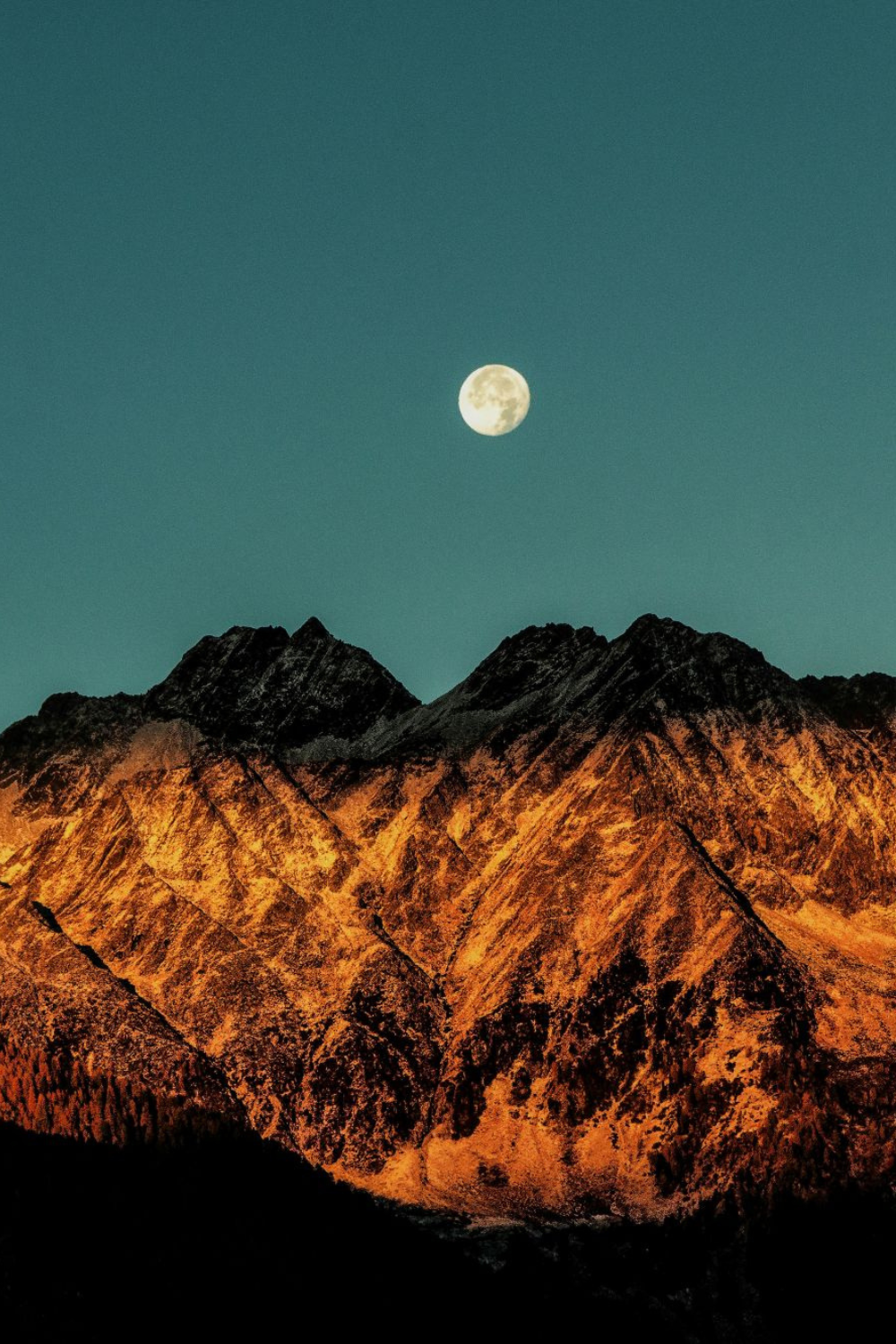 Moon over the mountains symbolizing planetary activation